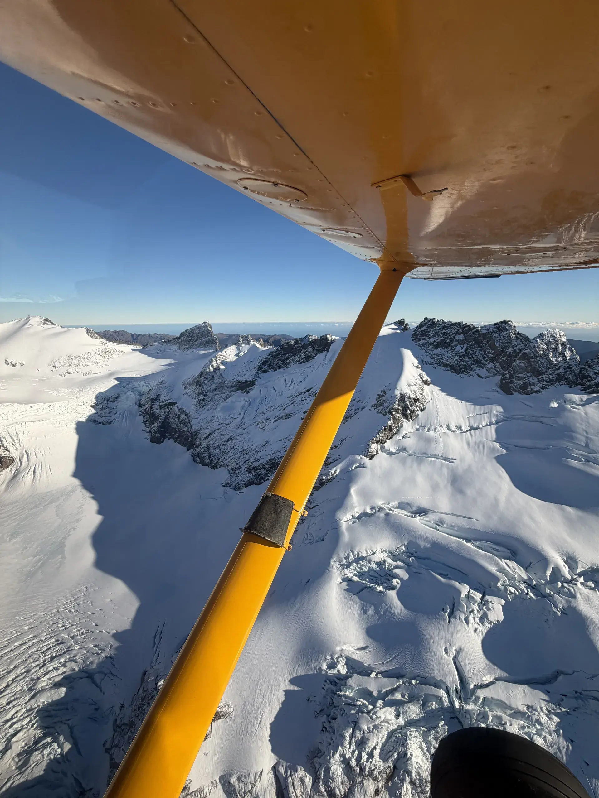 Snow-covered peaks of the Southern Alps from the cabin of a Flyinn Cessna