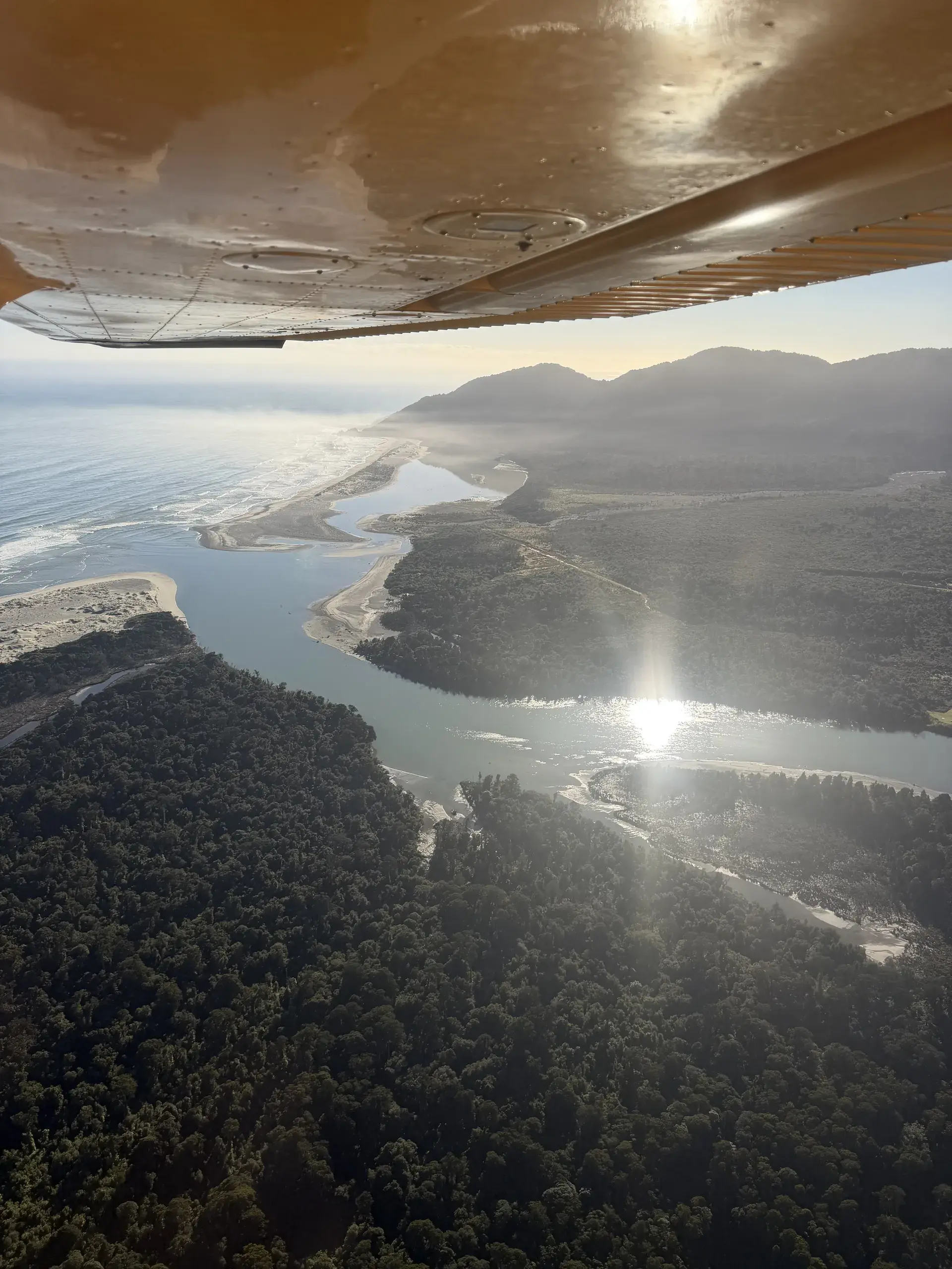 Golden afternoon light over a West Coast river mouth