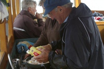Captain John preparing blue cod for lunch on Rawhiti2. Stewart Island. John and Kathy. Mar 09