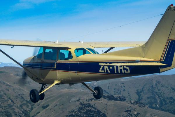 Yellow Cessna plane flying