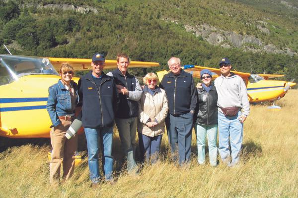 Group shot in front of Yellow Cessna