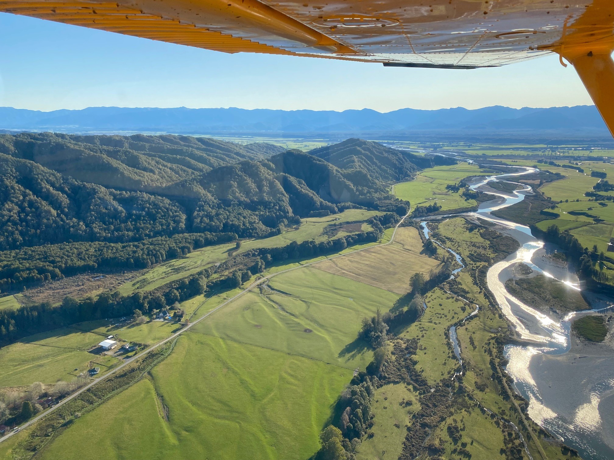 Native bush boundaries farmed valley flats.